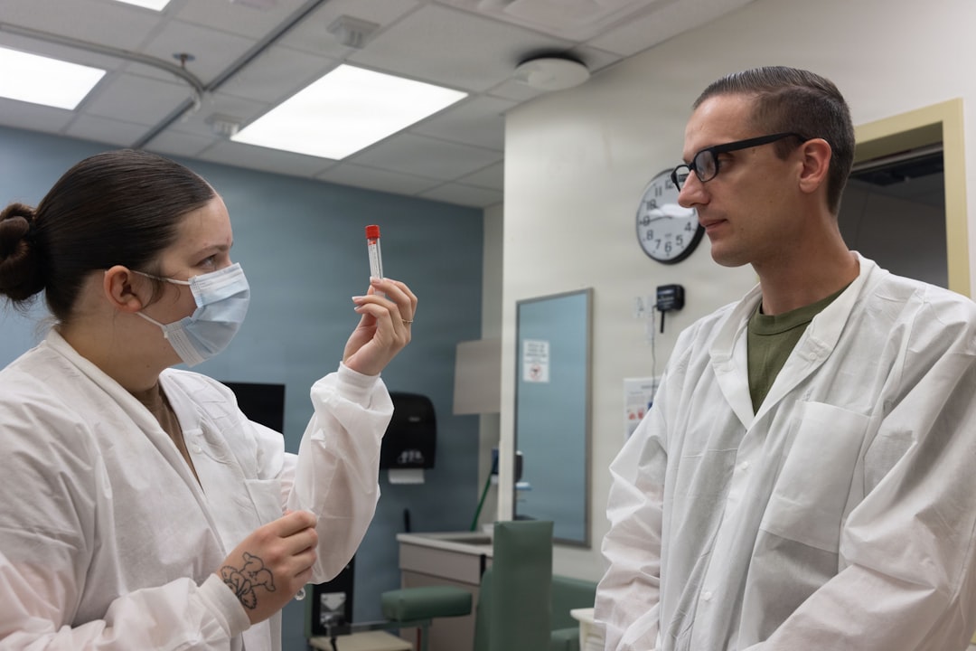 Thyroid Screening for Women: Full Panel Testing vs TSH Only Two medical professionals in lab coats examine a test tube.