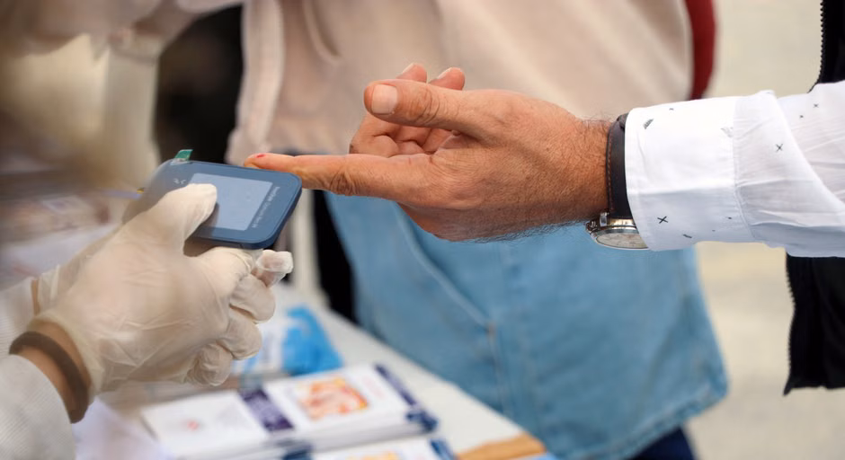 Advanced Lipid Panels: Particle Size and Density Testing Beyond Cholesterol A healthcare professional checks blood glucose at a public event.
